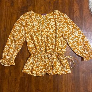 Size large blouse orange with floral white pattern. Great condition!